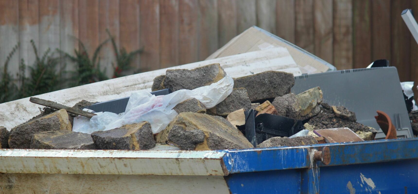 Blue skip containing rubble