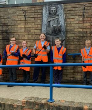 School litter pick kits from J&B recycling. School kids lined up with high vis jackets on