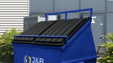 Blue front-end loader skip with J&B recycling logo