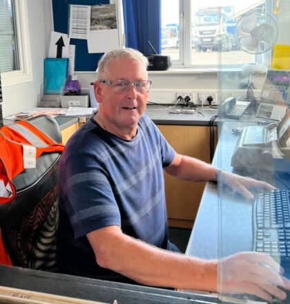 weighbridge operator at J&B Recycling sitting at desk in office