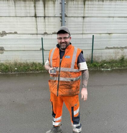 Team member in the yard at J&B recycling wearing overalls