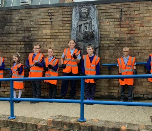 School litter pick kits from J&B recycling. School kids lined up with high vis jackets on