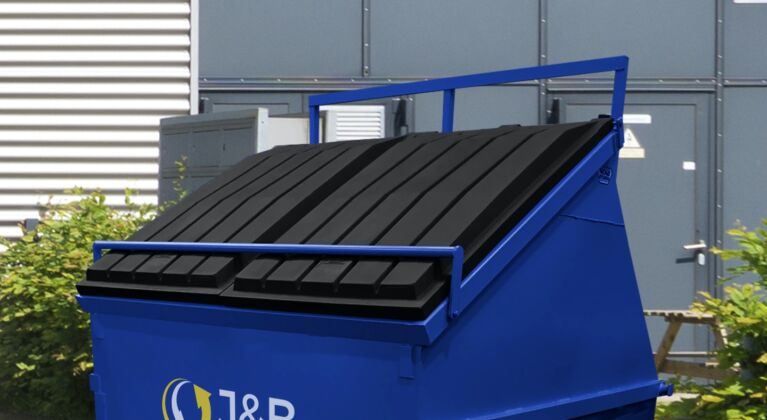 Blue front-end loader skip with J&B recycling logo